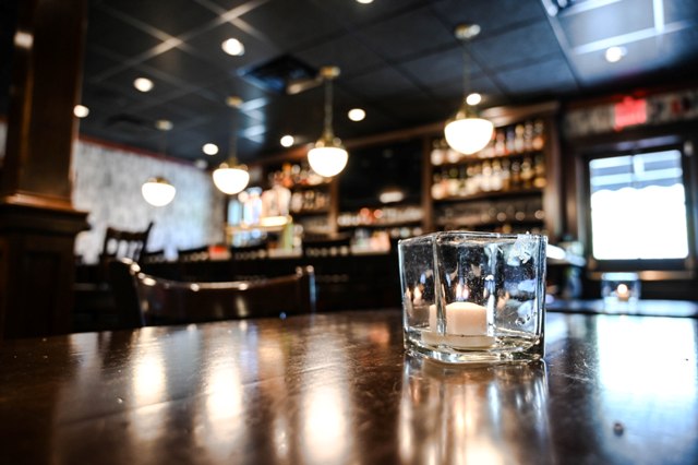 This is a photo of the Federal bar area from the view of a table. This photo shows the candle in focus and the backround blurred.